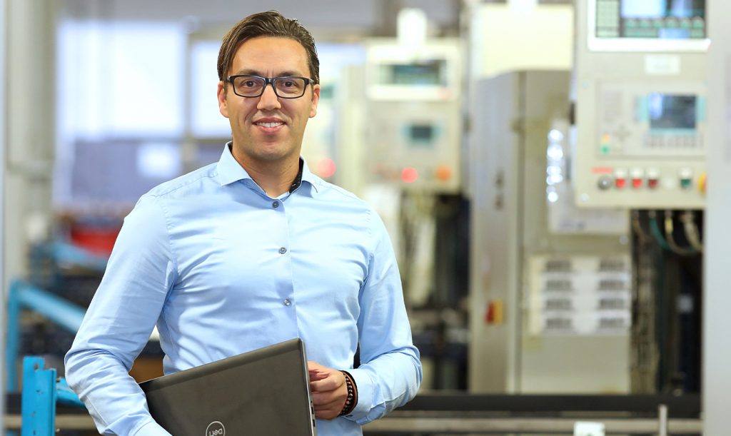 First service employee looks at the camera with laptop in hand